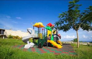 a park with a playground with a slide at Pyramid Point Vacation Stay in Ocho Rios