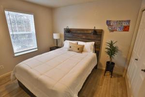a bedroom with a large white bed and a window at Peaceful Retreat In The Heart Of Missoula in Missoula