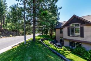 a house with a tree on the side of the road at Peaceful Retreat In The Heart Of Missoula in Missoula