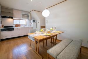 a kitchen with a wooden table and a dining room at ArudenaiDay in Tokushima