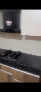 a black stove top oven in a kitchen at Wave executive floors in Ghaziabad