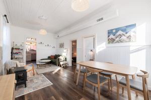 a living room with a wooden table and a dining room at Historic Boho Brothel Lake Retreat Fast Wifi in Twin Lakes