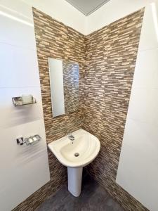 a bathroom with a sink and a mirror at La Belle Homestay in Kandy