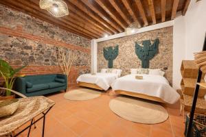 two beds in a room with a brick wall at DH3 VIP & Luxurious 2beds APT in Historic Center in Mexico City +10 photos