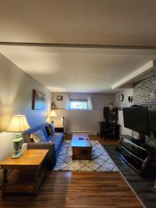 a living room with a blue couch and a tv at Two bedroom apartment in Torbay in Torbay
