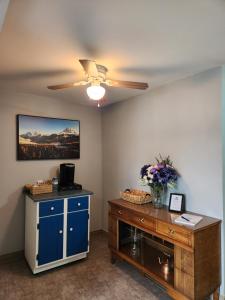 a room with a blue cabinet and a ceiling fan at Two bedroom apartment in Torbay in Torbay +10 photos