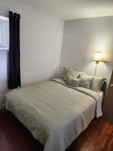 a bedroom with a large bed with a lamp at Two bedroom apartment in Torbay in Torbay