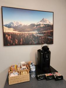 a coffee maker on a table with a picture on the wall at Two bedroom apartment in Torbay in Torbay