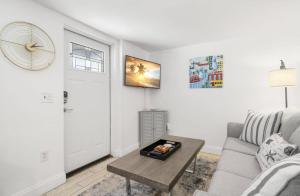 a living room with a couch and a table at Little Hyde Out - Updated Hyde Park 1st Floor Apartment in Tampa