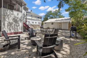 a patio with chairs and a table and a grill at Little Hyde Out - Updated Hyde Park 1st Floor Apartment in Tampa