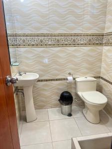 a bathroom with a toilet and a sink at HOTEL SAMANAHUASi in Nazca +53 photos