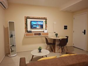 a living room with a couch and a table at Dpto Resort zona aeropuerto in Luque +33 photos