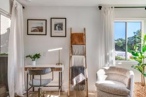 ein Wohnzimmer mit einem Schreibtisch, einem Stuhl und einem Tisch in der Unterkunft Ritz Pointe Paradise! in Dana Point
