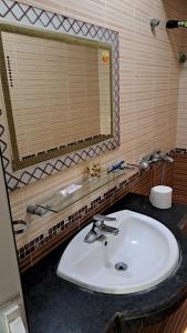 a bathroom with a white sink and a mirror at 88 Ehome Noibai Airport in Hanoi +120 photos