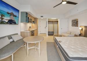 a bedroom with a bed and a table and a couch at NEW Luxury Bay View Downtown Studio in Miami +35 photos