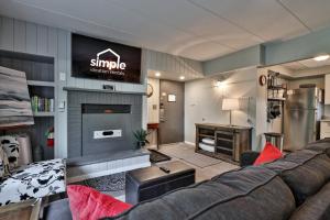 a living room with a couch and a fireplace at The Snowshed Steps at Mt Green - Walk-to-Lifts Ski Condo with Pools, AC, Fireplace & Shuttle! in Killington