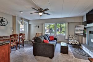 a living room with a couch and a table at The Snowshed Steps at Mt Green - Walk-to-Lifts Ski Condo with Pools, AC, Fireplace & Shuttle! in Killington