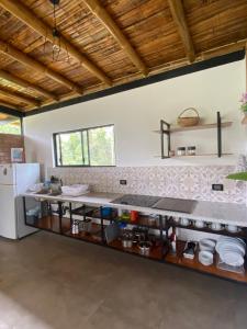 a kitchen with a counter and a white refrigerator at Wasi loma casa campestre in Pedro Vicente Maldonado +10 photos
