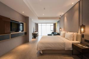Ένα ή περισσότερα κρεβάτια σε δωμάτιο στο Atour S Hotel Dongzhimen Beijing +42 φωτογραφίες