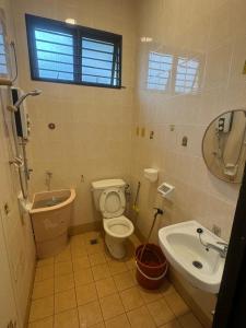 a bathroom with a toilet and a sink at Taman Sri Utama Gurun 