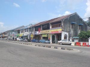 a street with cars parked on the side of the road at Taman Sri Utama Gurun  +2 photos