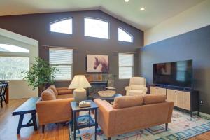 a living room with two couches and a flat screen tv at Picturesque Pueblo At Palmer Lake Sleeps 14 in Palmer Lake