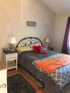 a bedroom with a large bed with pillows on it at Beautiful Four Bedroom Lagoon City Waterfront Home in Brechin