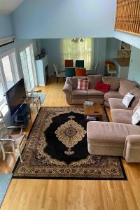 a living room with a couch and a rug at Beautiful Four Bedroom Lagoon City Waterfront Home in Brechin