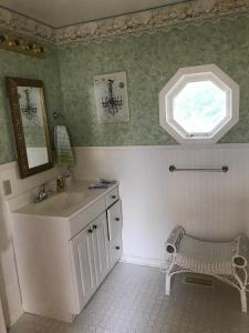 a bathroom with a sink and a window at Beautiful Four Bedroom Lagoon City Waterfront Home in Brechin +24 photos