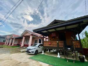 a house with a car parked in front of it at Bushriah Homestay Pendang in Pendang