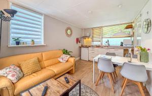 a living room with a couch and a table at 2 Bedroom Beach Front Home In Egmond Aan Zee in Egmond aan Zee