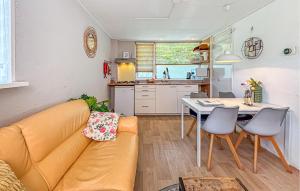 a living room with a couch and a table at 2 Bedroom Beach Front Home In Egmond Aan Zee in Egmond aan Zee