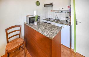 a kitchen with a counter with a sink and a microwave at Maison Avec Piscine in Villars