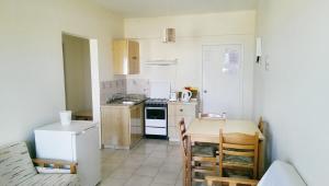 a small kitchen with a table and a stove at Maouris Hotel Apartments in Protaras