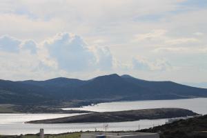 a view of a large body of water with mountains at Bonatsa House in Agios Georgios