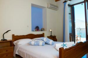 a bedroom with a bed with two pillows on it at Kamares Studios in Symi