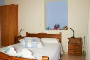a bedroom with a bed with towels on it at Kamares Studios in Symi