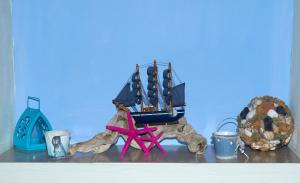 a figurine of a boat on a shelf at Kamares Studios in Symi