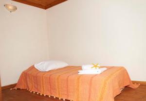 a bedroom with a bed with towels on it at Kamares Studios in Symi