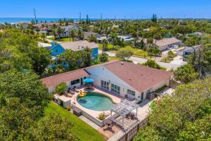 an aerial view of a house with a swimming pool at 218 Fifth Avenue in Melbourne Beach