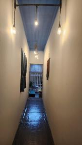 a long hallway with lights on the walls of a room at LoCo House in Con Dao +2 photos