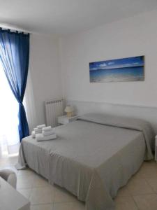 a bedroom with a large bed and a window at B&B MA.RE. in Otranto