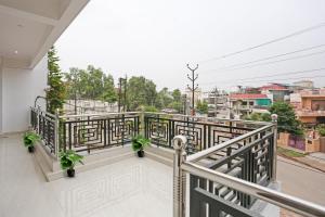 a balcony with a view of a city at Hotel O Citylight in Colonelganj +39 photos