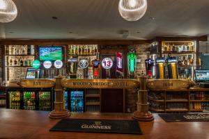 a bar that has a lot of bottles on it at Woodenbridge Hotel in Arklow