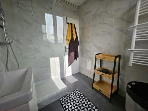 a bathroom with a tub and a sink and a shower at Appartements Pavillons-sous-bois in Les Pavillons-sous-Bois