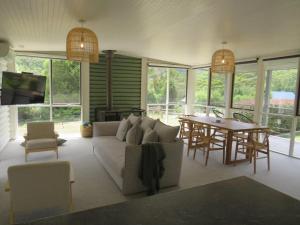 a living room with a couch and a table at Changue Buller Views in Merrijig