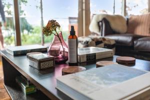 a table with a bottle of wine and a book at Green Stones in Howqua