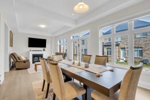 a dining room and living room with a table and chairs at Relaxed Oakville Vacation Stay for 8 or more in Oakville