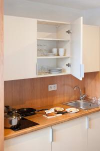 a kitchen with white cabinets and a counter top at Apartamenty Turek in Turek