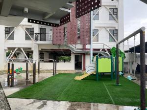 an empty playground in front of a building at Deluxe 2 Bedroom Condo Royal Oceancrest Mactan in Mactan Island